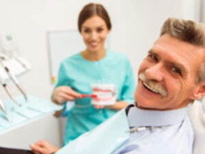 old man in a dental clinic smiling