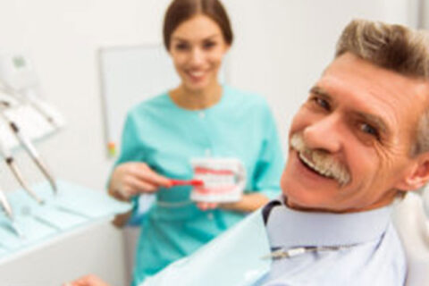 old man in a dental clinic smiling